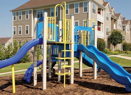 Playground Area with two blue slides and property in the background at Chesapeake Ridge, Maryland