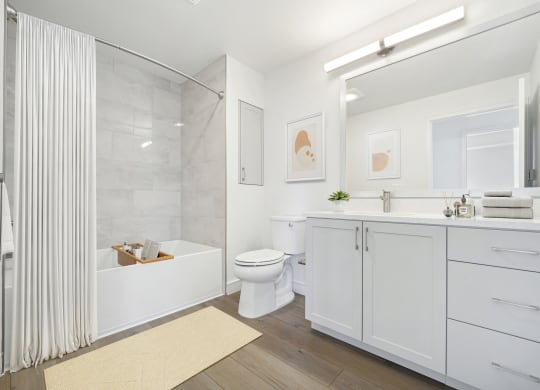 a white bathroom with a shower and a toilet