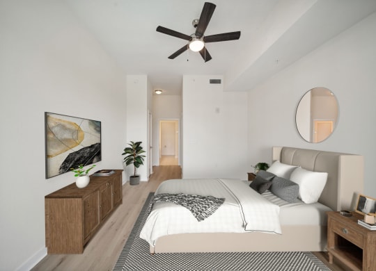 a bedroom with a large bed and a ceiling fan