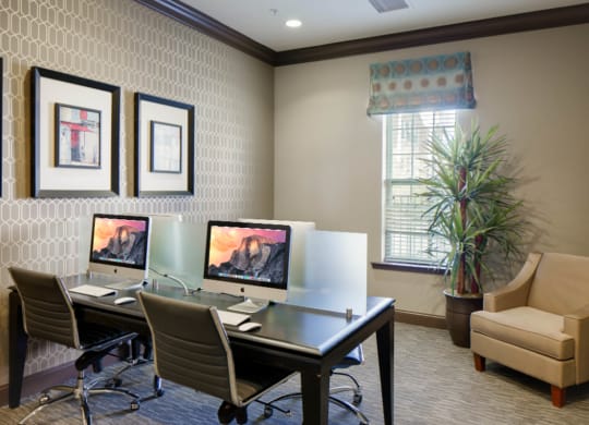two computers sitting on a desk in a room