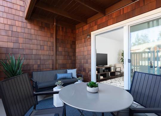 A patio with a table and chairs.