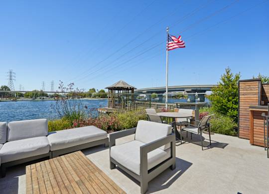 outdoor seating area with grills in background