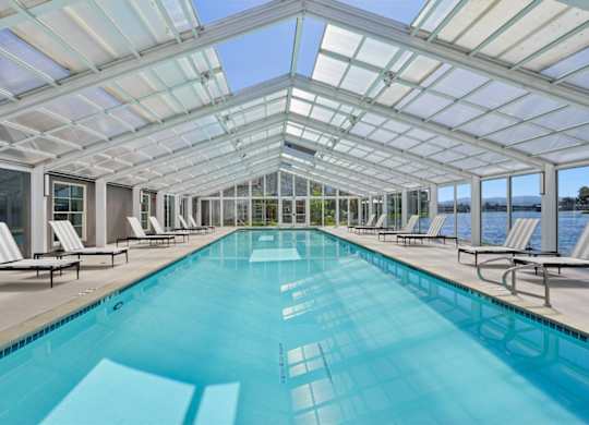 greenhouse-style pool house with swimming pool