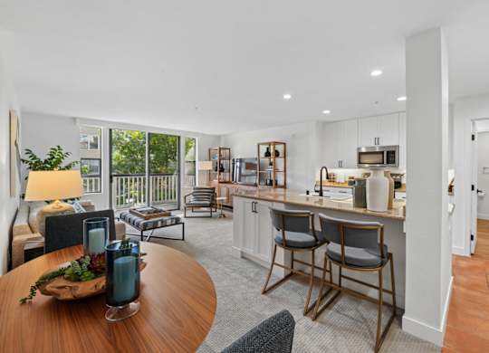 Open-concept dining and kitchen area at Marlin Cove Apartments with breakfast bar and modern finishes.