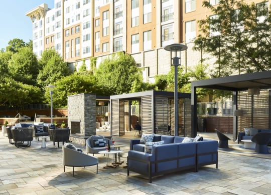 a rendering of a patio with couches and chairs at a hotel