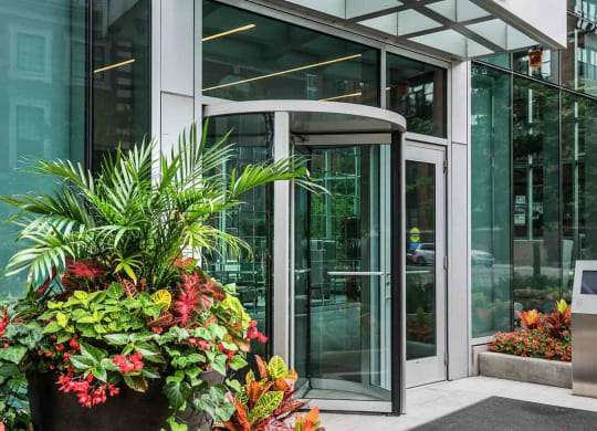 a glass revolving door in front of a building