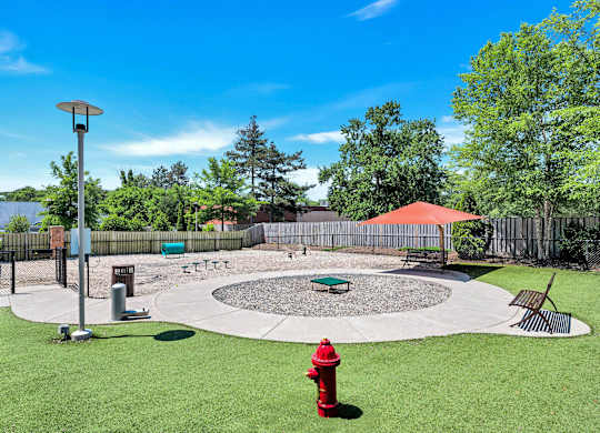 A red fire hydrant sits in the middle of a grassy yard.
