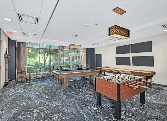 A room with a pool table and a billiard table.