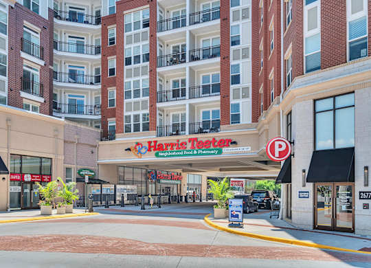 A Harris Teeter store is located in front of a large apartment building.