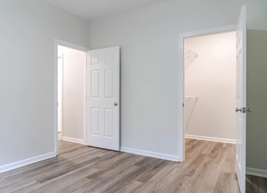 a bedroom with an open door and a closet
