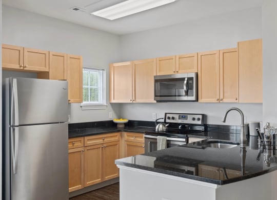 a kitchen with wooden cabinets and stainless steel appliances