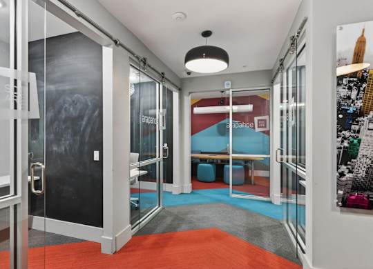 A room with a glass door and a red carpet.