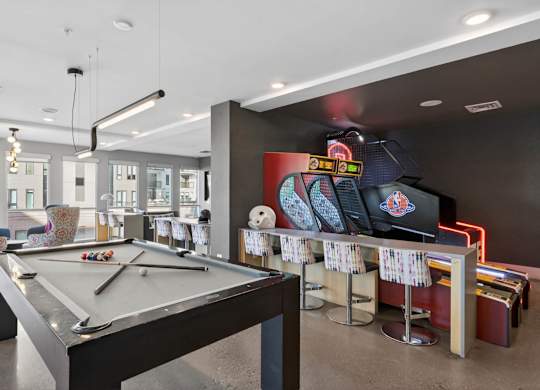Billiards area in indoor lounge with seating nearby.