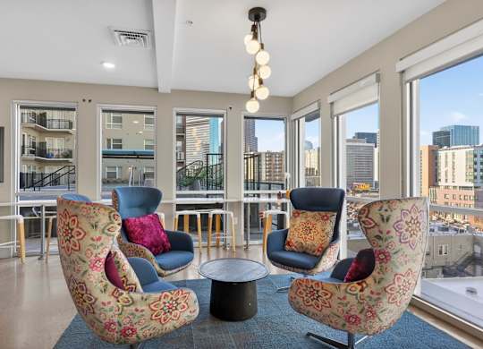 Modern indoor lounge with seating, game tables, and open common area.