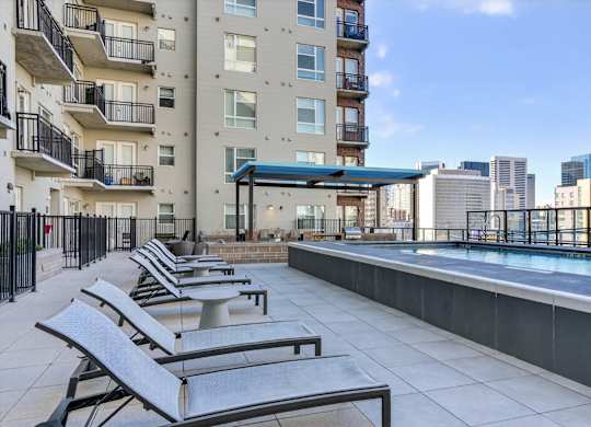 Pool area with lounge chairs.