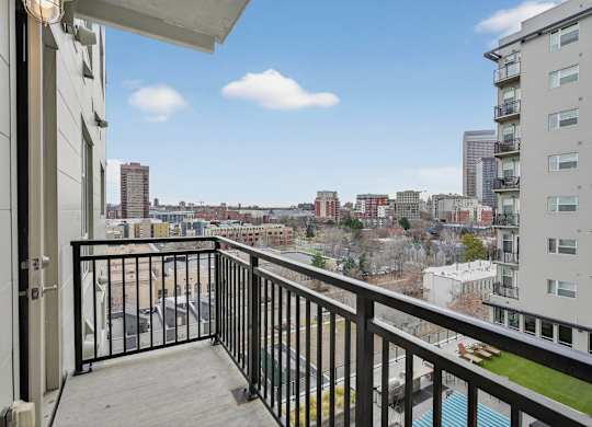 Apartment balcony with city skyline views.