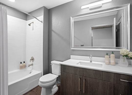 Modern apartment bathroom with sleek vanity and contemporary fixtures.