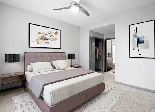 Apartment bedroom designed for relaxation with natural light and modern accents.