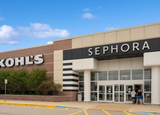the facade of a sephora store with two people walking out of the door
