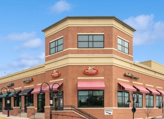 the outside of a burger king restaurant with pink awnings