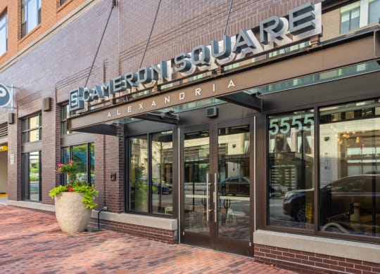 a store front of a brick building with glass windows and a sign on the front