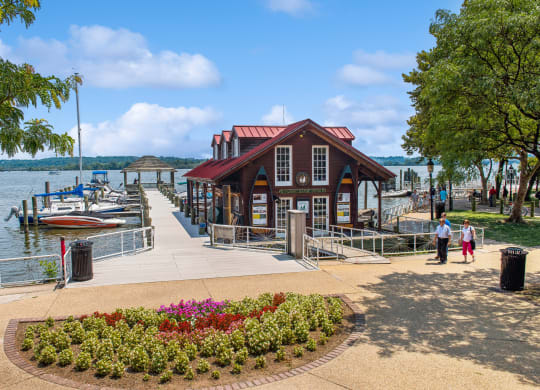 a marina with boats and a building on the water