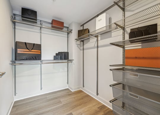 a room with a closet with shelves and a television