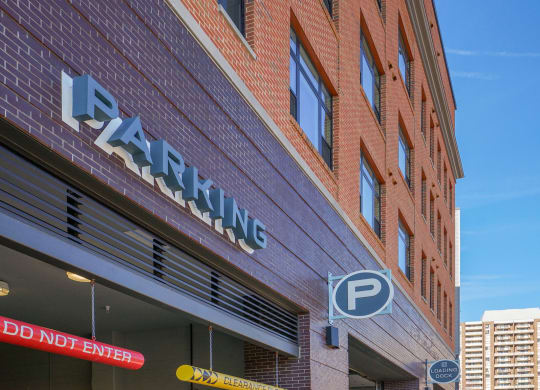 a brick building with a parking sign on the side of it