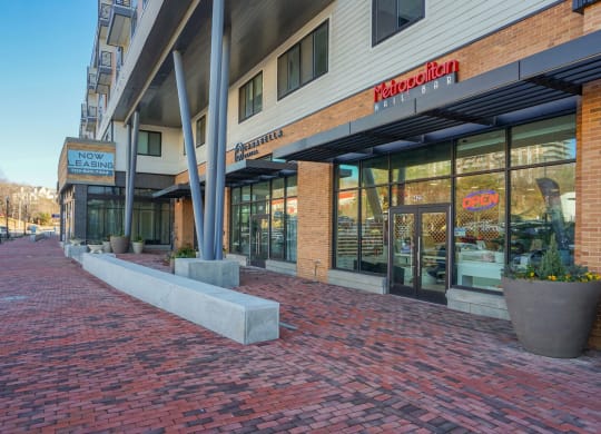 a street view of a building with a brick sidewalk