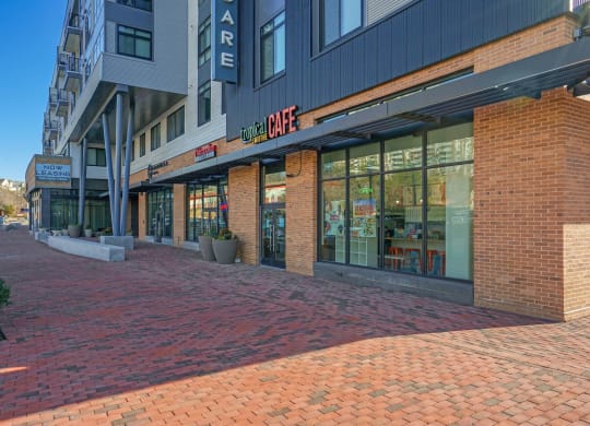 a brick sidewalk in front of a building on a city street