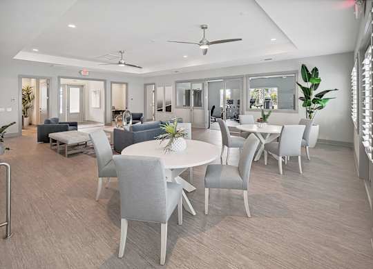 A spacious room with a dining table and chairs.