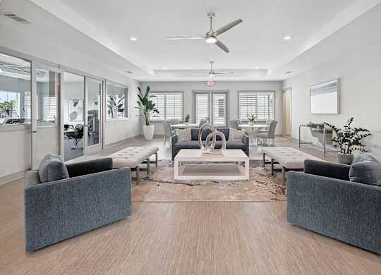 A modern living room with a grey sofa set and a wooden floor.