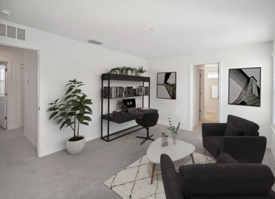 a living room with two black couches and a white coffee table
