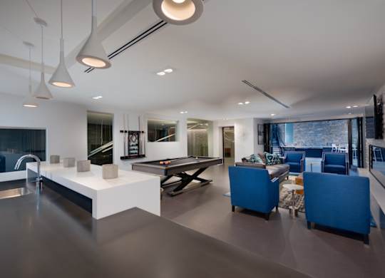 A modern kitchen with a dining area and a living room.