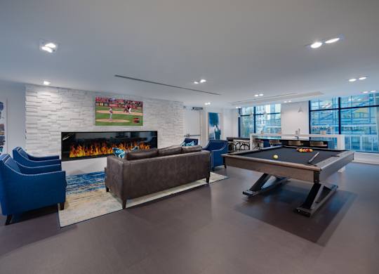 A room with a pool table and a fireplace.