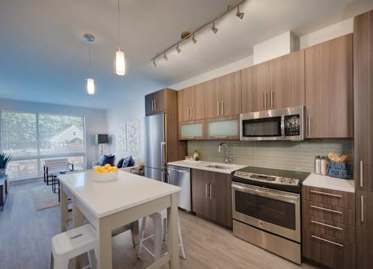 A modern kitchen with a dining table and chairs.