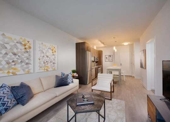 A living room with a white couch and a coffee table.