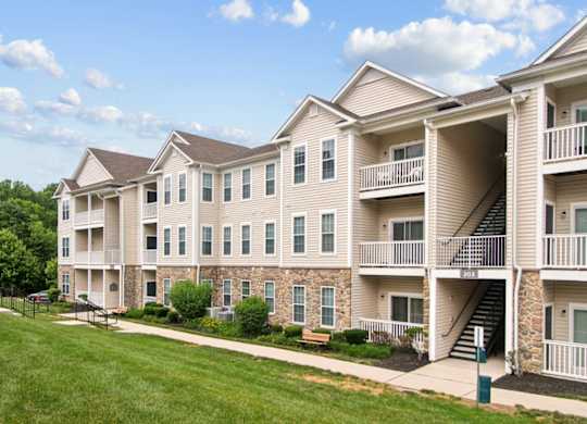Apartment building with a green lawn in front.