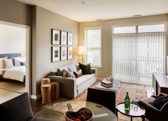 A living room with a couch, coffee table and wall art.