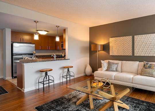 Living room with vinyl plank flooring and view of kitchen