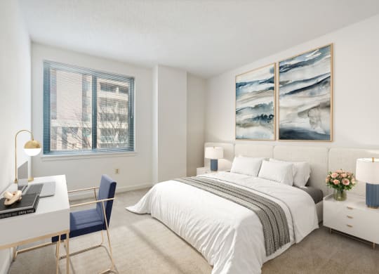 a bedroom with a bed and a desk and a window
