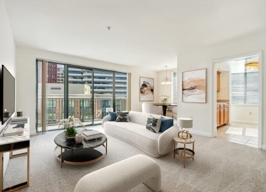 a living room with a white couch and a large window
