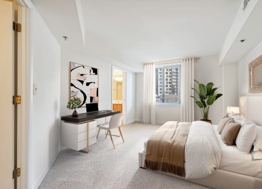 a bedroom with a bed and a desk and a window
