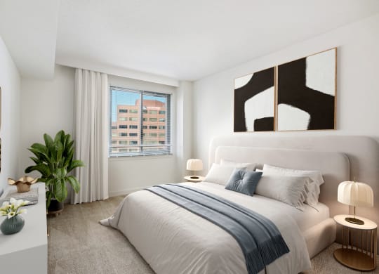 a bedroom with a bed and a large window