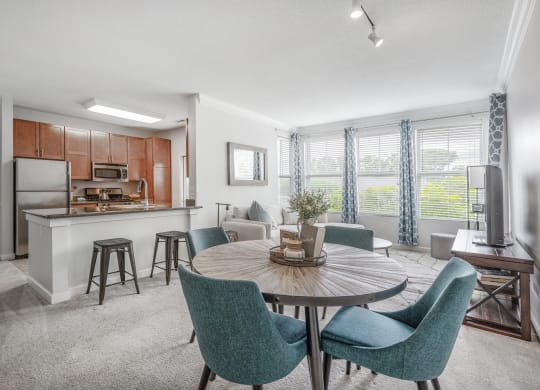 a living room with a kitchen and a dining table