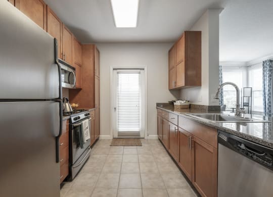 a kitchen with stainless steel appliances and wooden cabinets
