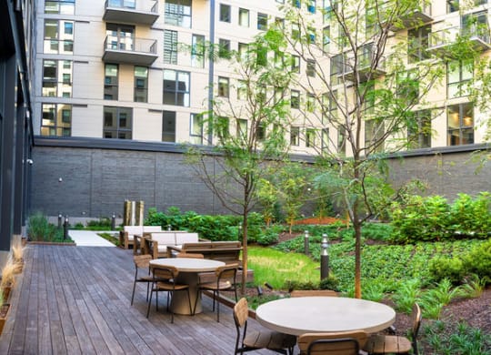 a patio with tables and chairs in a courtyard