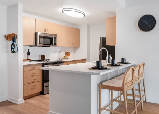 a kitchen with an island with two stools in front of it