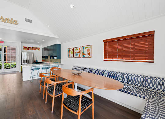 Resident clubhouse at Sunnyvale apartment community with large windows and seating