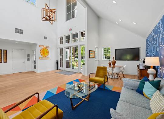 Intimate clubhouse lounge at Sunnyvale apartment community with soft seating